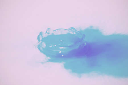 Colorful paint drop splashing on black a background Vintage Retro Filter.の写真素材