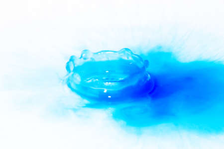 Colorful paint drop splashing on black a backgroundの写真素材