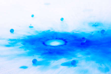 Colorful paint drop splashing on black a background