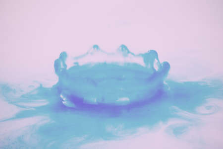 Colorful paint drop splashing on black a background Vintage Retro Filter.の写真素材