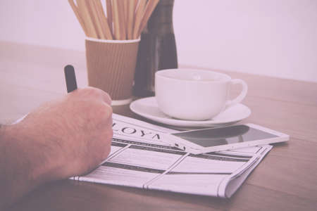 Searching for a new job or employment in a newspaper Vintage Retro Filter.の写真素材