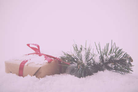 Christmas presents wrapped in brown paper with red ribbon Vintage Retro Filter.の写真素材