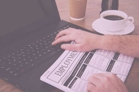 Searching for a new job or employment in a newspaper Vintage Retro Filter.の写真素材
