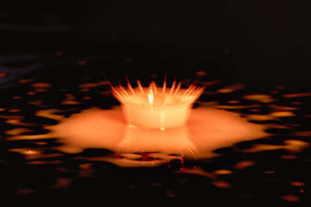 Colorful paint drop splashing on black background
