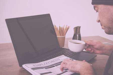 Searching for a new job or employment in a newspaper Vintage Retro Filter.の写真素材