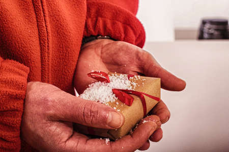 Open hands holding a present wrapped in a red ribbon HDR Filter.の写真素材