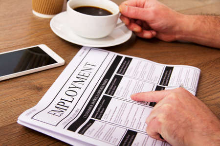 Searching for a new job or employment in a newspaperの写真素材