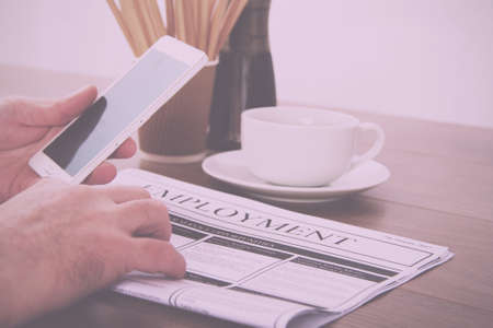Searching for a new job or employment in a newspaper Vintage Retro Filter.の写真素材