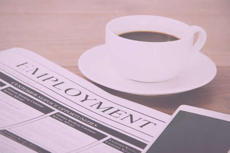 Searching for a new job or employment in a newspaper Vintage Retro Filter.の写真素材