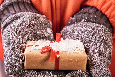 Open hands holding a present wrapped in a red ribbon HDR Filter.の写真素材