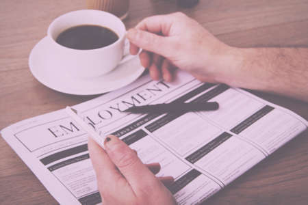 Searching for a new job or employment in a newspaper Vintage Retro Filter.