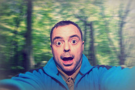 Man talking selfie while spinning on blurred background