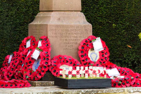 Poppies left at a memorial during a Rememberance Day Serviceの写真素材