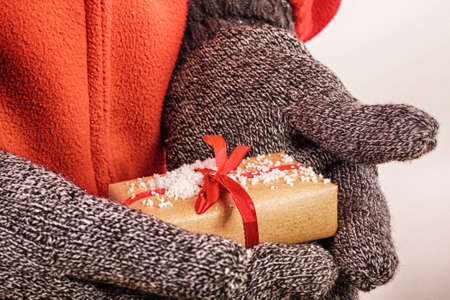 Open hands holding a present wrapped in a red ribbon HDR Filter.の写真素材