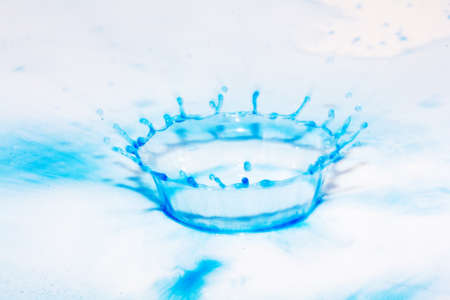 Colorful paint drop splashing on black a backgroundの写真素材