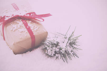 Christmas presents wrapped in brown paper with red ribbon Vintage Retro Filter.の写真素材