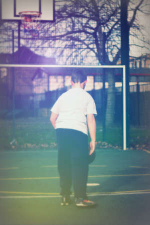Child practicing playing basketball in a local parkの写真素材