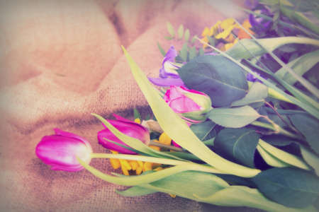 Spring cut flower arrangement against a rustic backgroundの写真素材