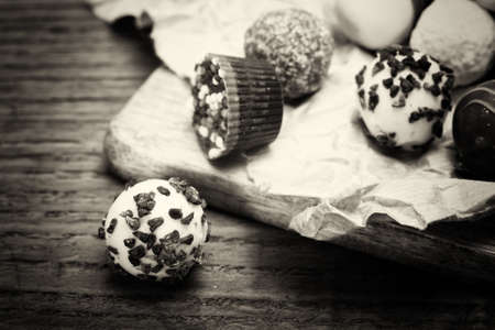 Selection of delicious chocolates on rustic backgroundの写真素材