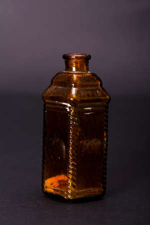 Old colourful vintage bottles against a dark backgroundの写真素材