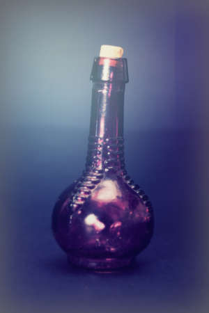 Old colourful vintage bottles against a dark backgroundの写真素材