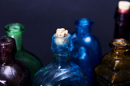 Old colourful vintage bottles against a dark backgroundの写真素材