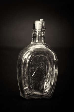 Old colourful vintage bottles against a dark backgroundの写真素材