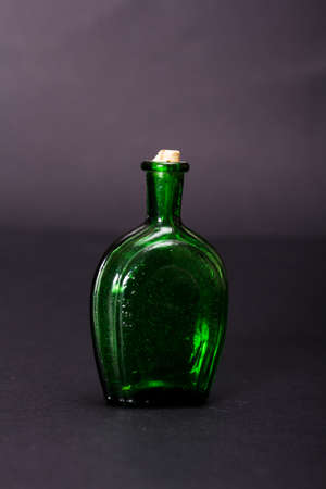 Old colourful vintage bottles against a dark backgroundの写真素材