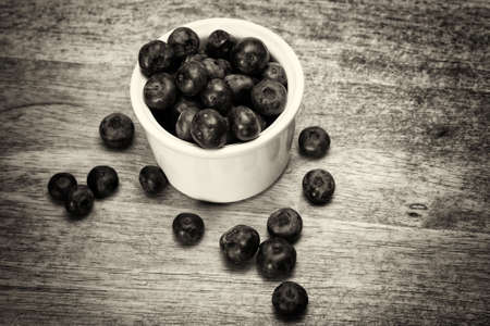 Pot of blueberries on a rustic wooden backgroundの写真素材