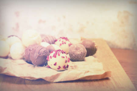 Selection of delicious chocolates on rustic backgroundの写真素材