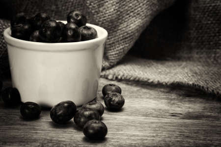 Pot of blueberries on a rustic wooden backgroundの写真素材