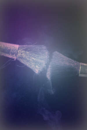 Make up brush with purple dust on a black backgroundの写真素材