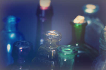 Old colourful vintage bottles against a dark backgroundの写真素材