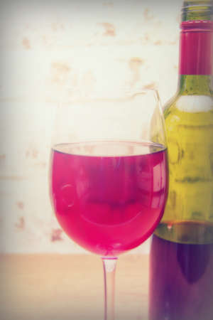 Bottle of red wine with glass ready to be pouredの写真素材