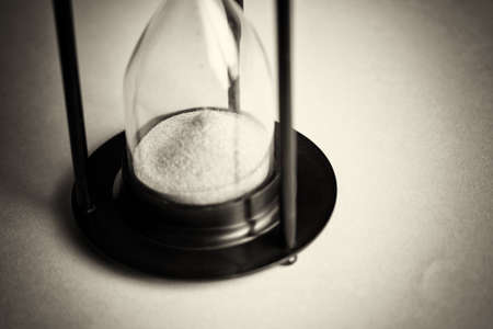 Large black hourglass against a light blue background