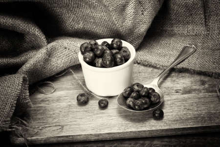 Pot of blueberries with spoon on a rustic wooden backgroundの写真素材