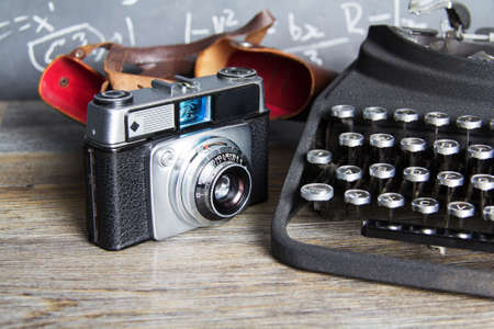 Old vintage retro camera with an old-fashioned typewriterの写真素材
