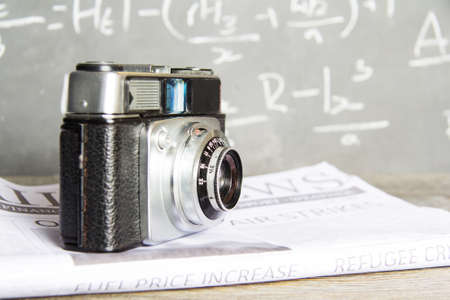 Old vintage retro camera with mocked up daily newspaperの写真素材