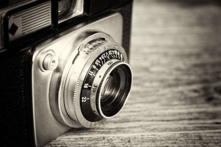 Old vintage retro camera on a wooden backgroundの写真素材