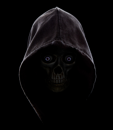Black hooded scull in the dark with blue eyes.Fear in the dark.の写真素材