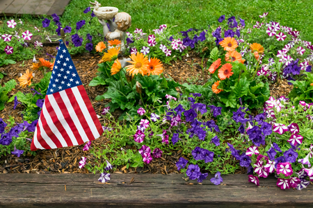 American flag in a vibrant flower garden on the fourth of Julyの写真素材
