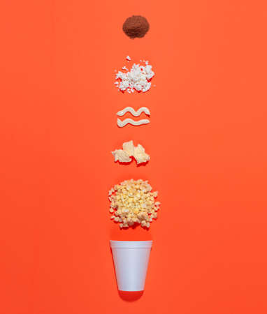 Mexican snack, two trolley, prepared esquite, corn in a cup, with chili powder on orange background, no peopleの写真素材
