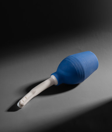 Large capacity enema for anal and vaginal douche, portable blue pump on gray background