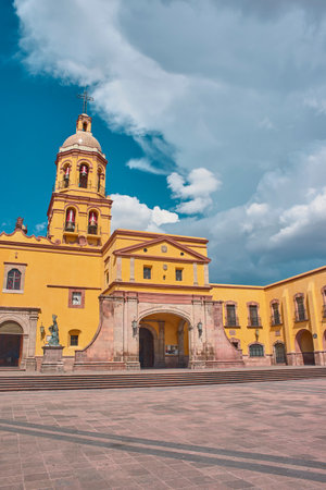 Santiago de Queretaro, Queretaro, Mexico, 09 07 22, Main entrance of the Temple and Convent of the Holy Cross of Miracles with a blue sky and clouds, no peopleのeditorial素材