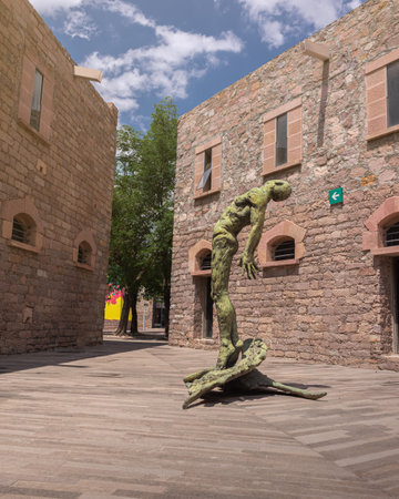 San Luis Potosi, San Luis Potosi, 23 04 08, Outdoor secondary courtyard, stone architecture with statue at the center of a naked man looking up at the sky inside the Leonora Carrington Museum, no peopleのeditorial素材
