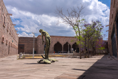 San Luis Potosi, San Luis Potosi, 23 04 08, Outdoor secondary courtyard, stone architecture with statue at the center of a naked man looking up at the sky inside the Leonora Carrington Museum, no peopleのeditorial素材