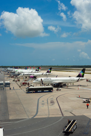 Cancun, Quintana Roo, 20 08 23, Mexican airline planes parked on the airport runway with passenger transport vehicles around them, air trafficのeditorial素材