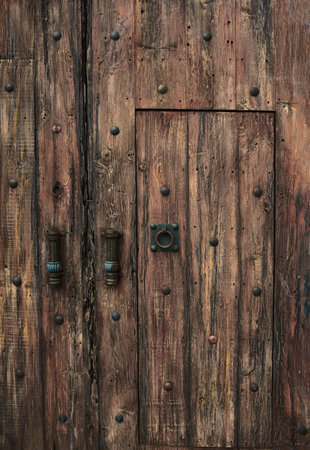 large old medieval style wooden door with bronze details and plates, no peopleの写真素材