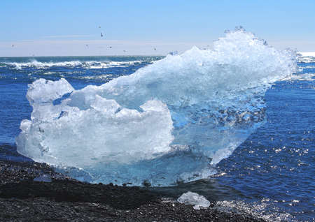 Impressive iceberg on the beach of Joekulsarlon (Iceland) in the sunの写真素材