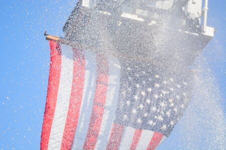 American flag closeup wet from water sprays at an outside event.